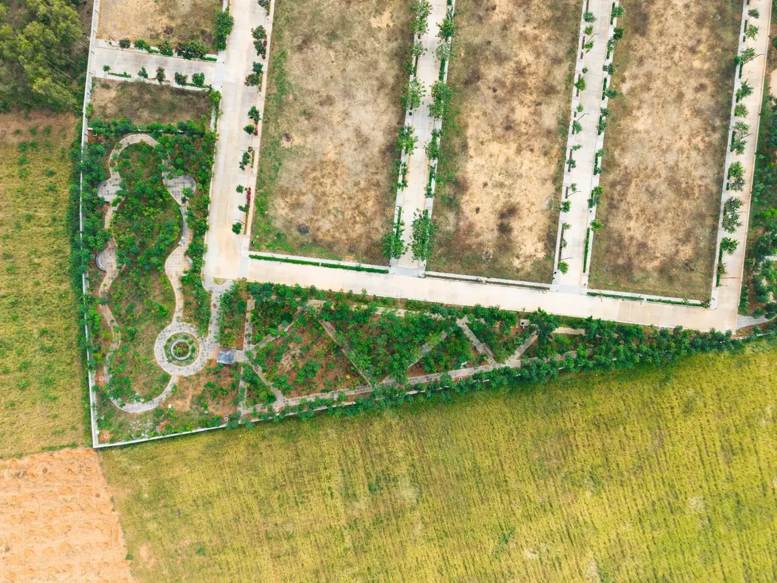 Top-down drone view of Aura Ville plots and parks